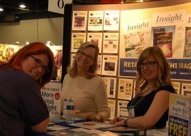 Jacki Smith of Coventry Creations and Molly Trimble and Maggie Feeney of Retailing Insight magazine spend a little time talking shop on the sales floor during INATS 2013.